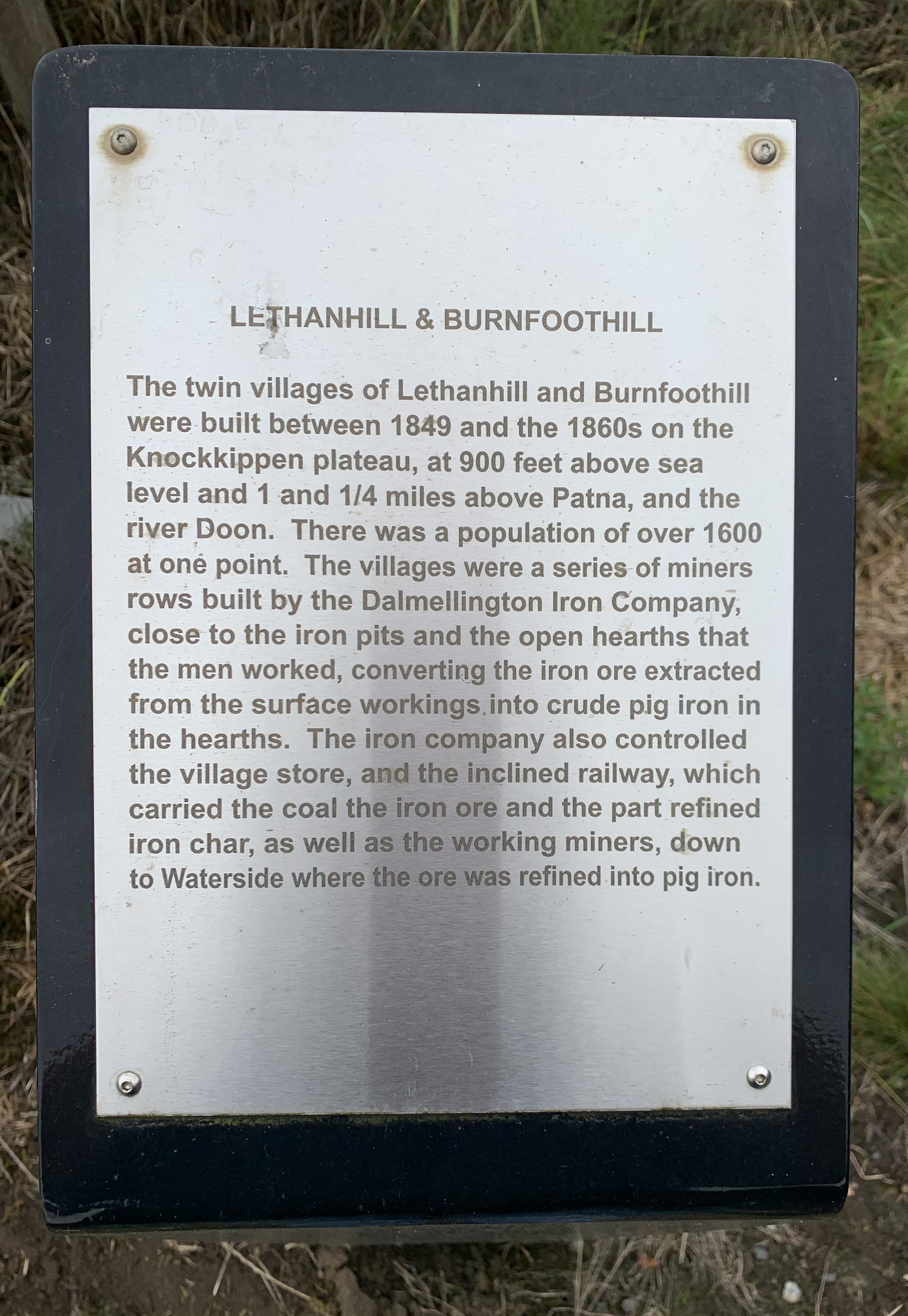 silver metal plaque on a black background marking the road up to the Ayrshire mining villages of Lethanhill and Burnfoothill 
