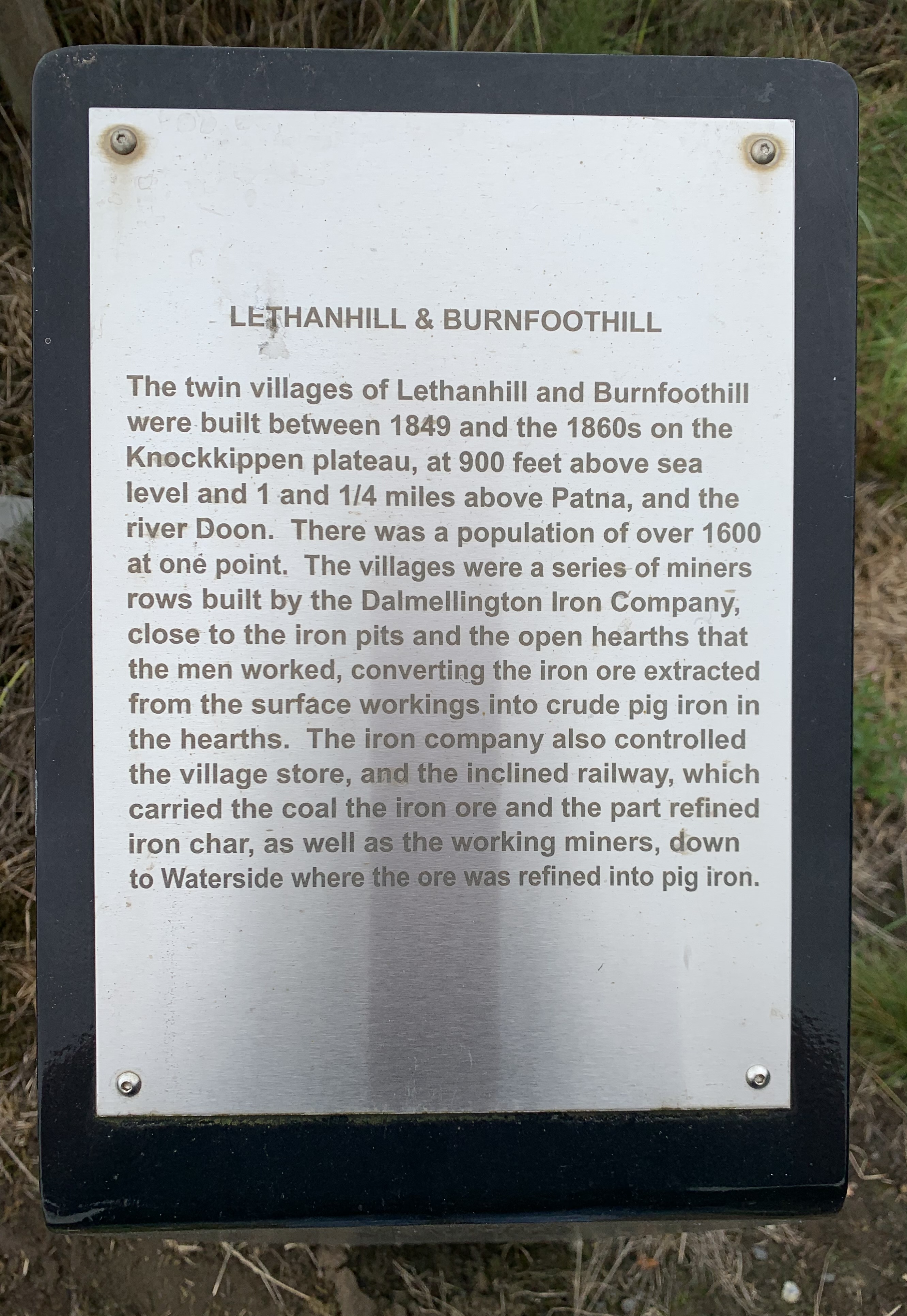 silver metal plaque on a black background marking the road up to the Ayrshire mining villages of Lethanhill and Burnfoothill