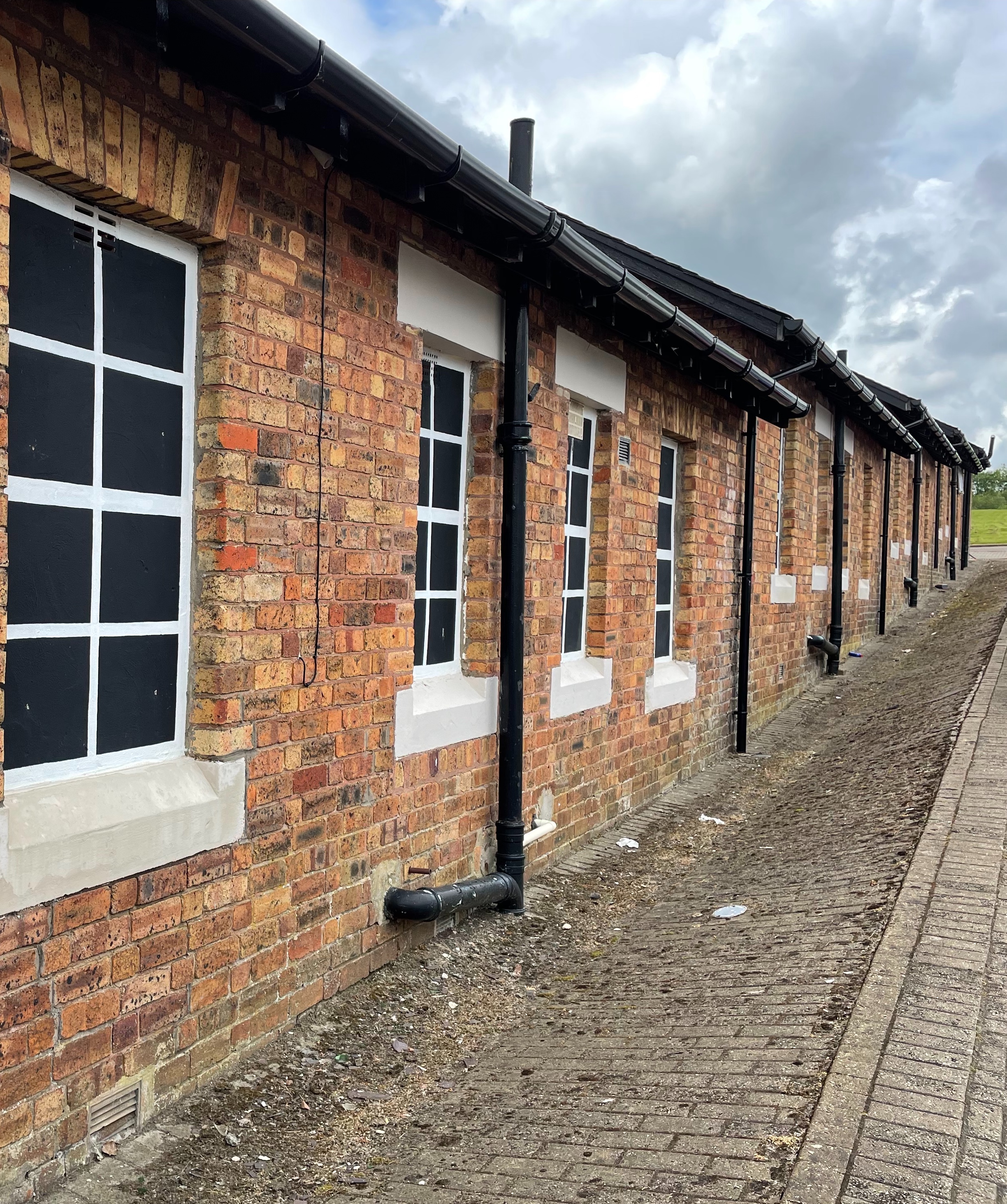 Row of single storey red brick houses