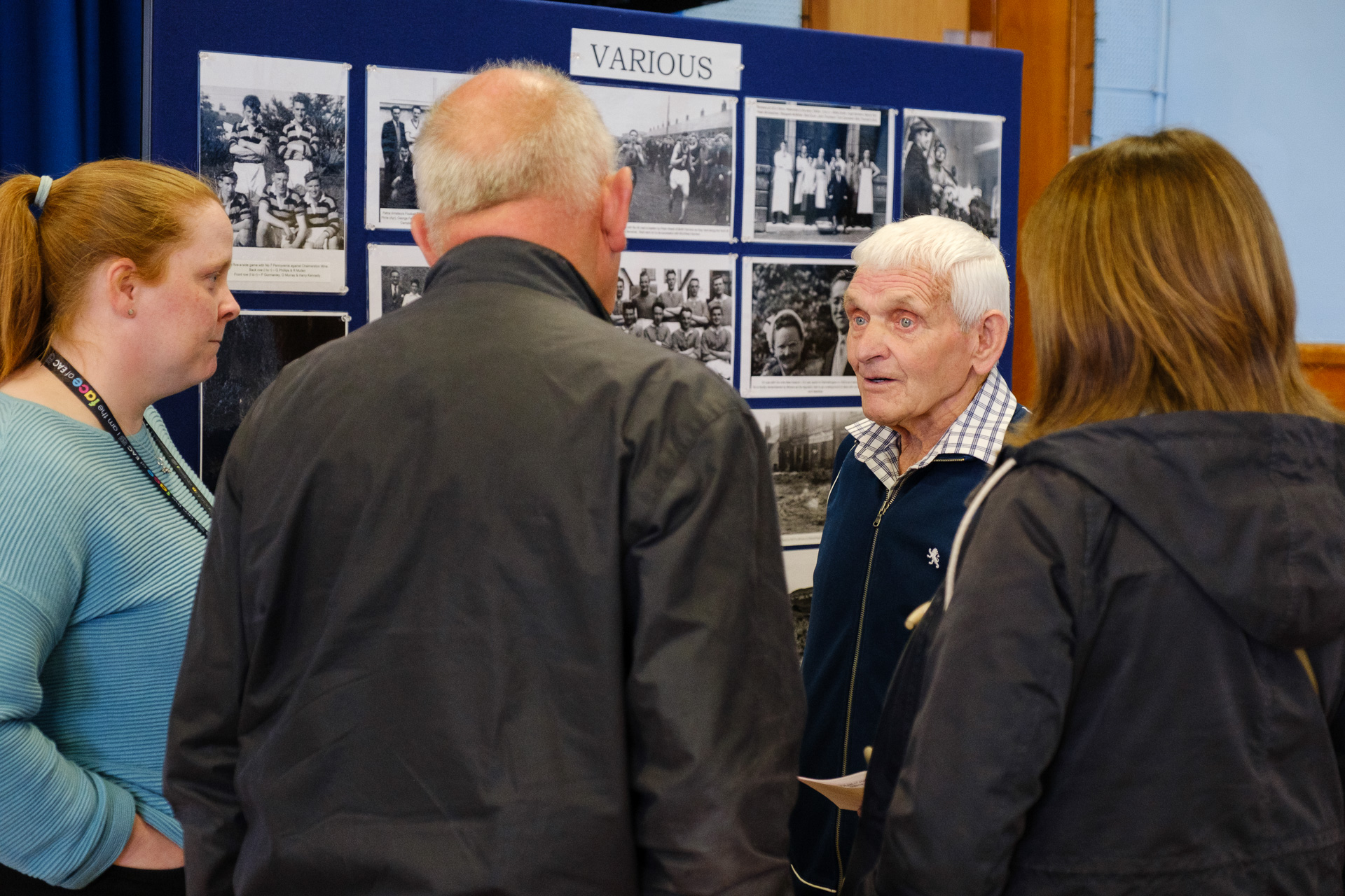 Group of people listening to a man talk